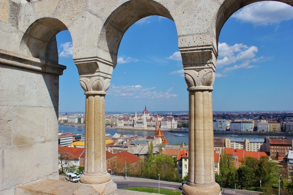 Castle Hill sights: Fisherman’s Bastion arched arcade with a peek at the Parliament Building across the Danube River.