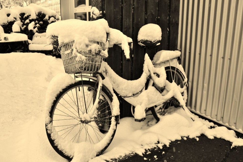 Iceland in Wintertime Snow covered bicycle JetSettingFools