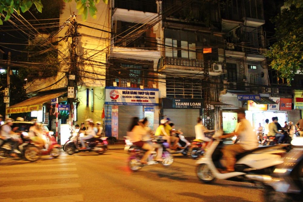 Watching scooter traffic in Hanoi is a great introduction to our 2-week Vietnam Itinerary