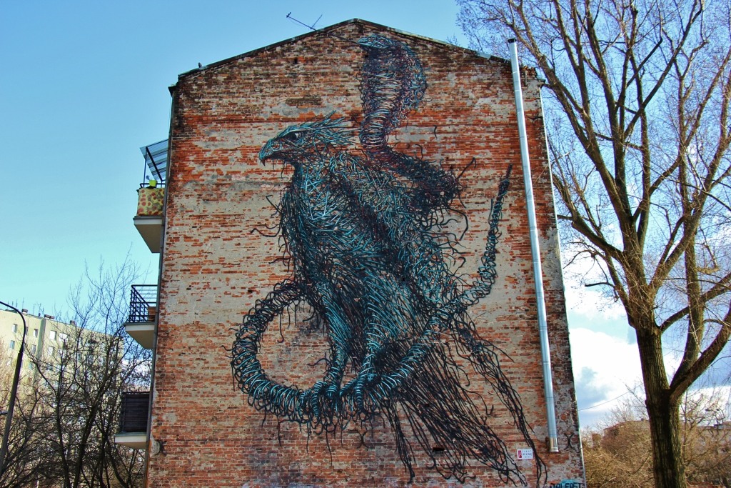 Bird and Snake wall mural street art in Praga neighborhood in Warsaw, Poland