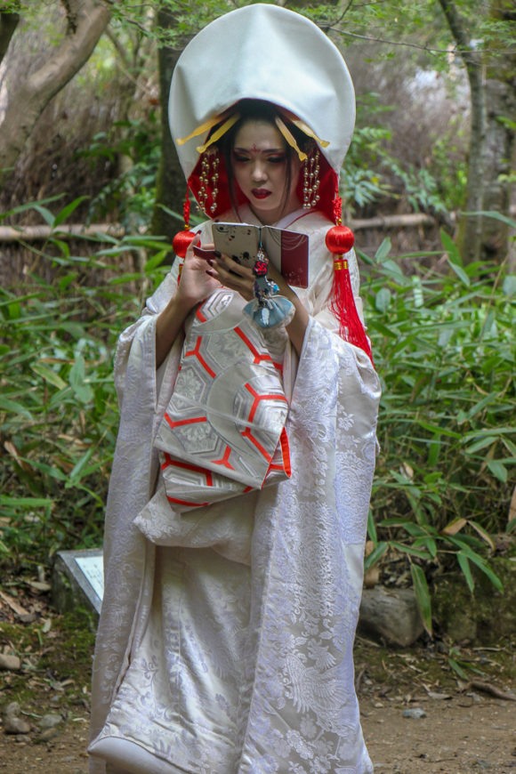 Girl in traditional dress on cell phone in Kyoto, Japan